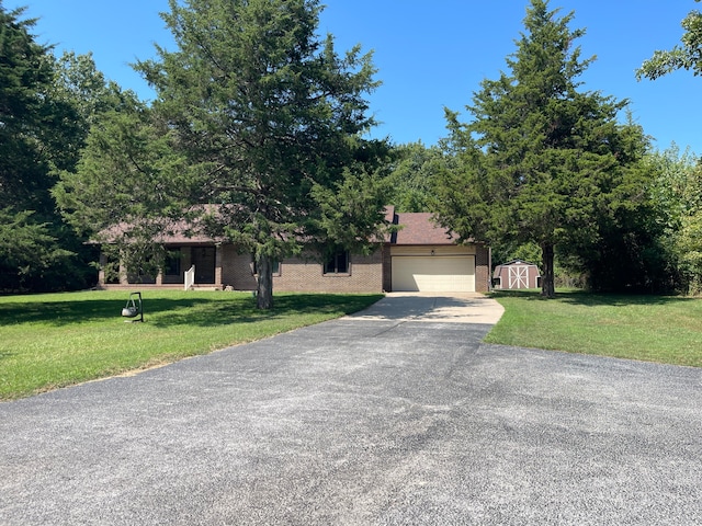 view of front of property with a front yard and a garage