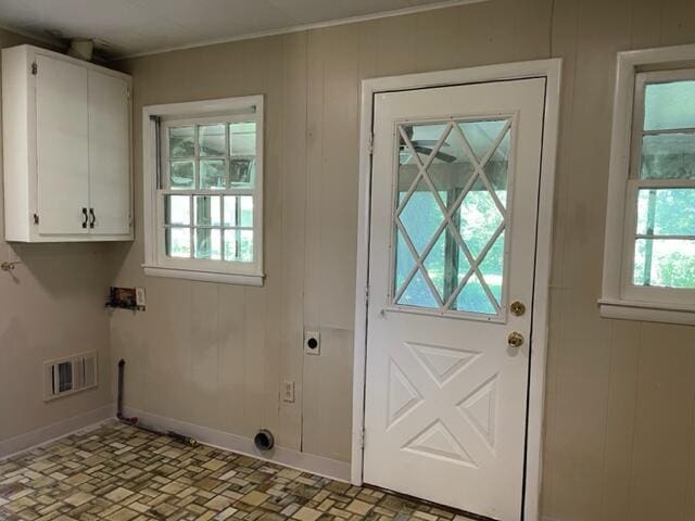 doorway featuring wood walls