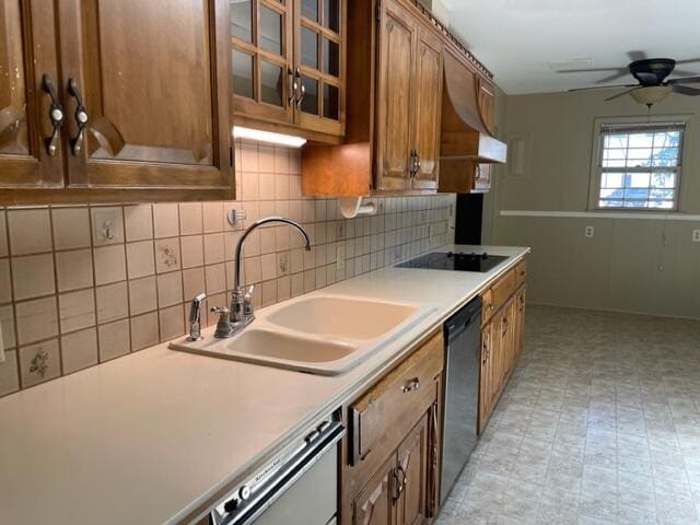 kitchen with black appliances, ceiling fan, sink, and tasteful backsplash