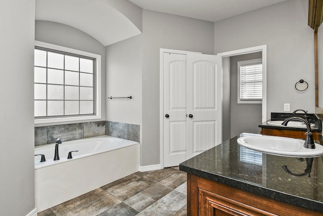 bathroom featuring vanity, hardwood / wood-style flooring, and a bathtub