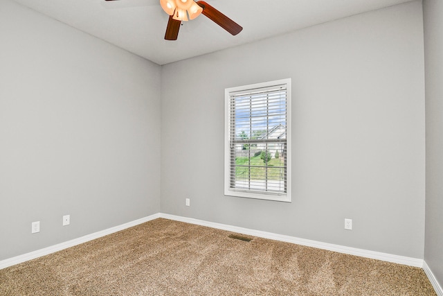 empty room with ceiling fan and carpet flooring