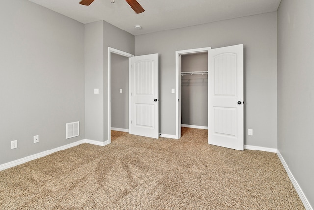 unfurnished bedroom with ceiling fan, a closet, and carpet flooring