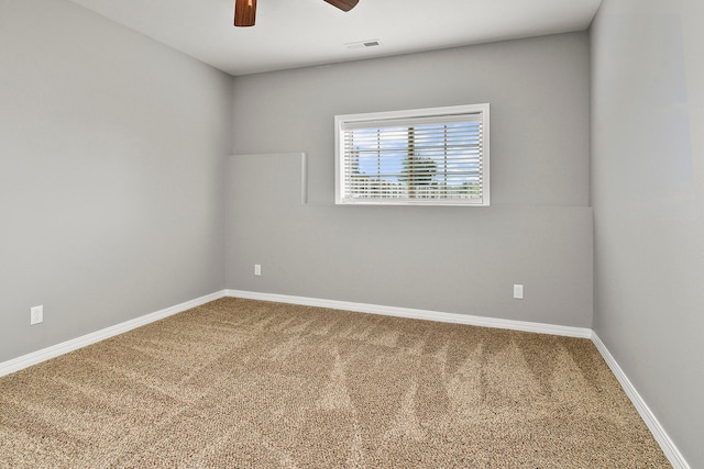 carpeted spare room featuring ceiling fan