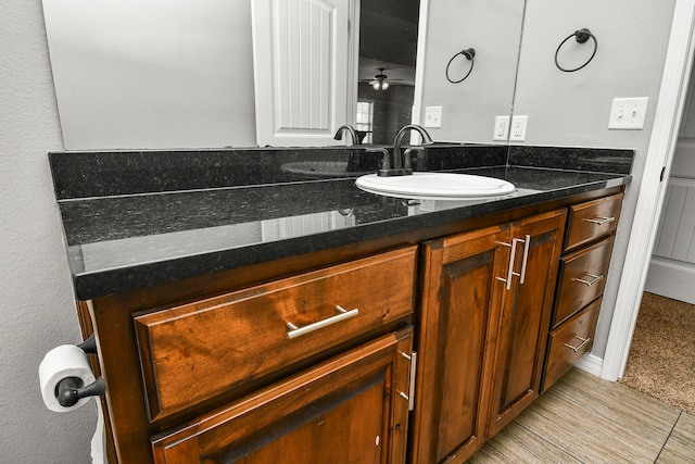 bathroom with ceiling fan and vanity