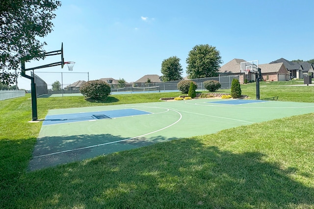 view of sport court featuring a lawn