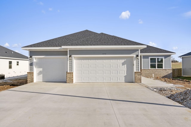 view of front of house featuring a garage and cooling unit