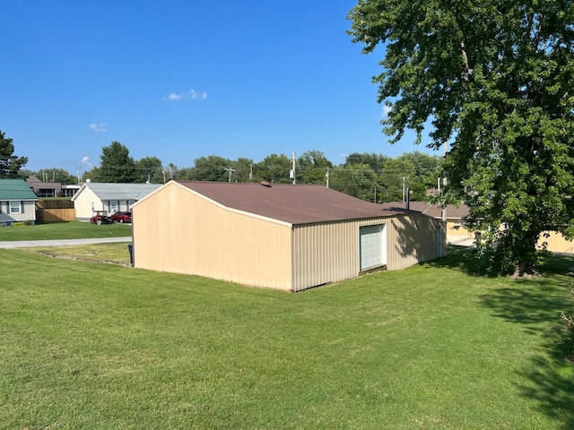 view of home's exterior featuring an outbuilding and a lawn