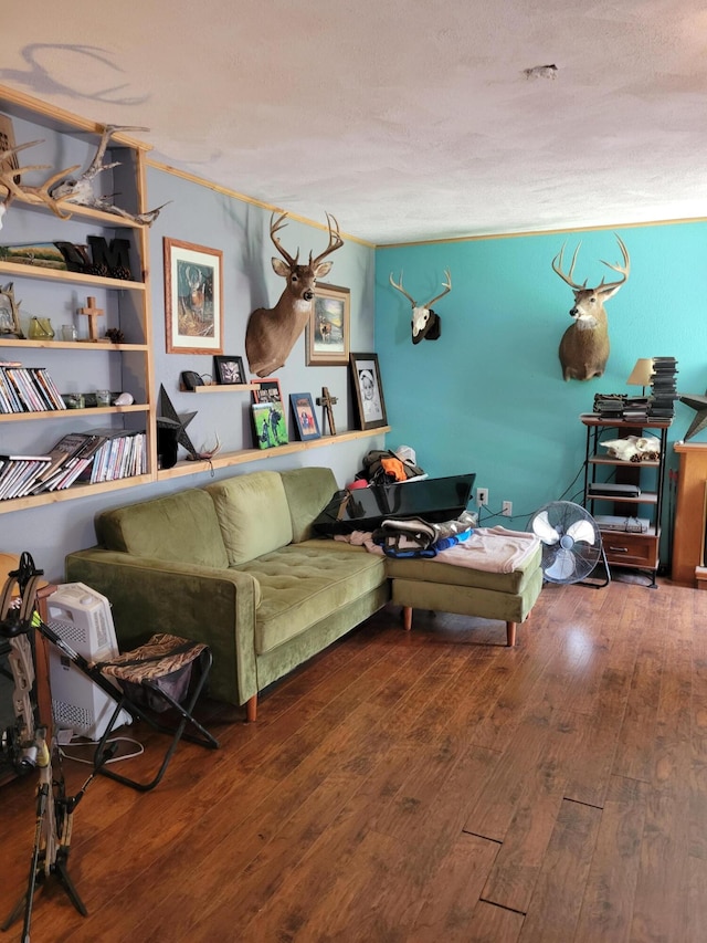 living room featuring wood-type flooring and a textured ceiling