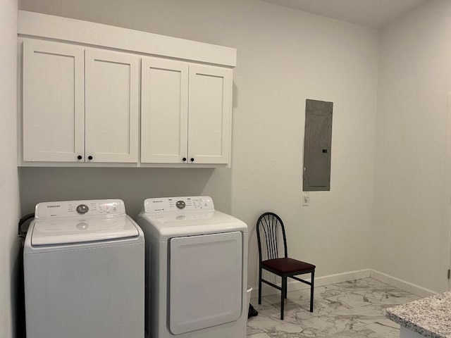 clothes washing area with cabinets, electric panel, and independent washer and dryer