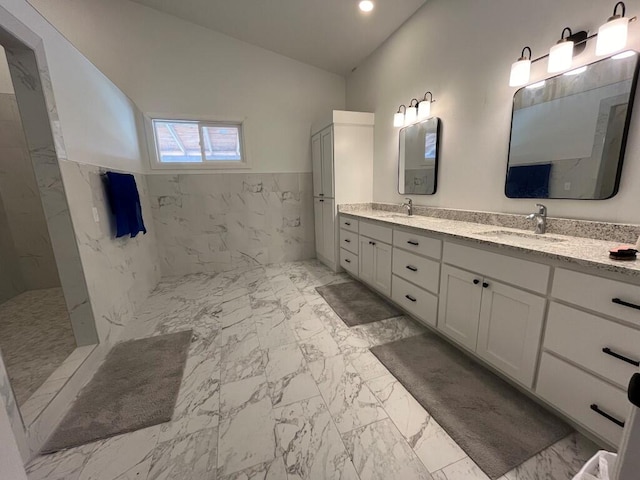 bathroom with vanity and tile walls