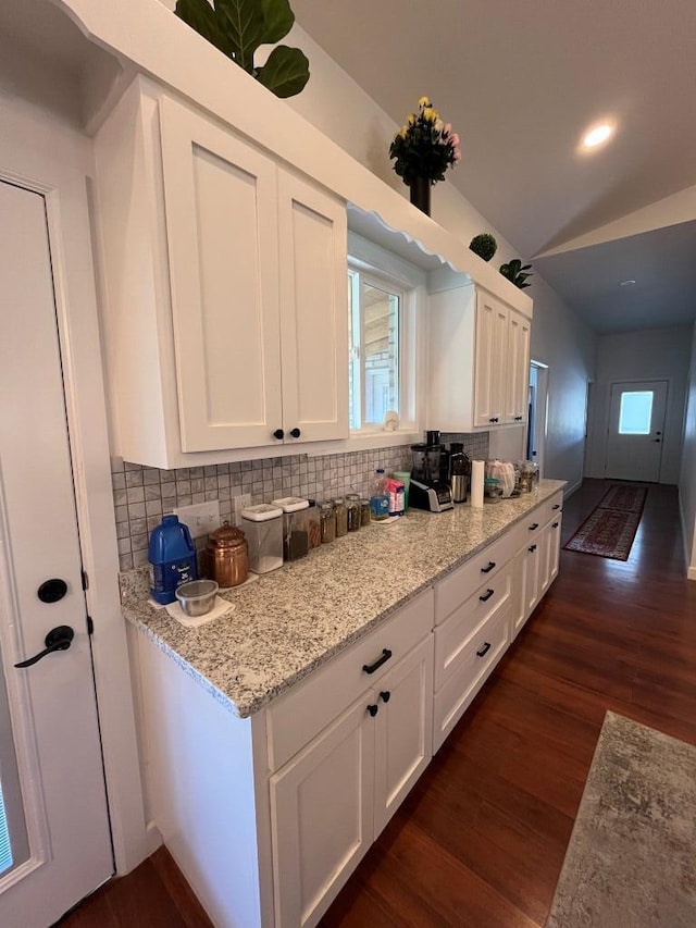 kitchen with dark hardwood / wood-style flooring, a healthy amount of sunlight, and white cabinetry