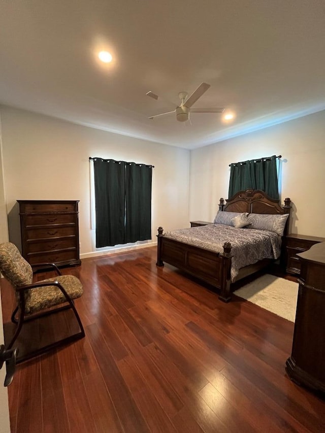 bedroom with ceiling fan and dark hardwood / wood-style flooring