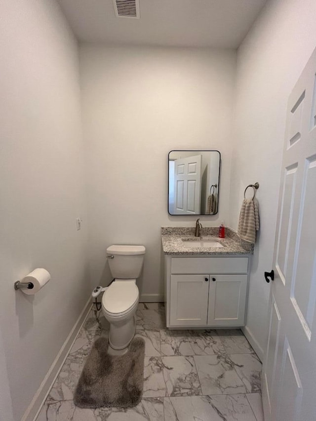 bathroom featuring vanity and toilet