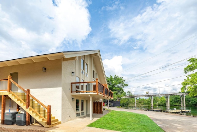 exterior space featuring cooling unit and stairway