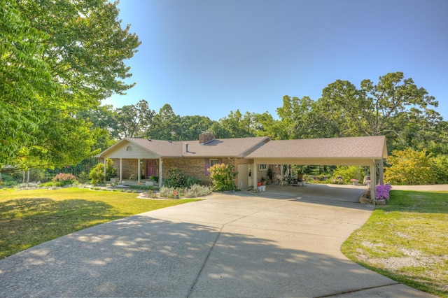 single story home with a front lawn and a carport