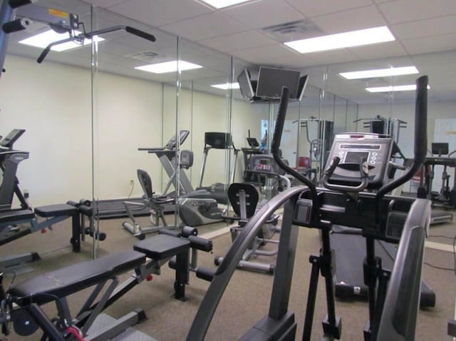 workout area with a paneled ceiling