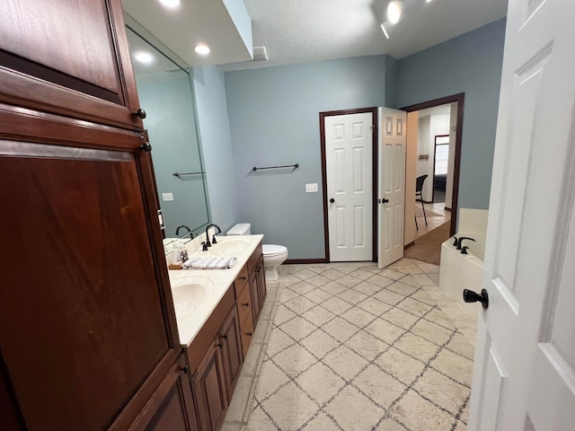 bathroom featuring a bath, vanity, and toilet