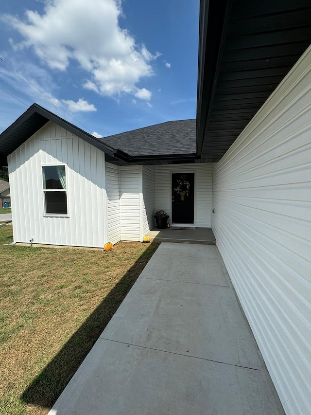 view of exterior entry with a lawn