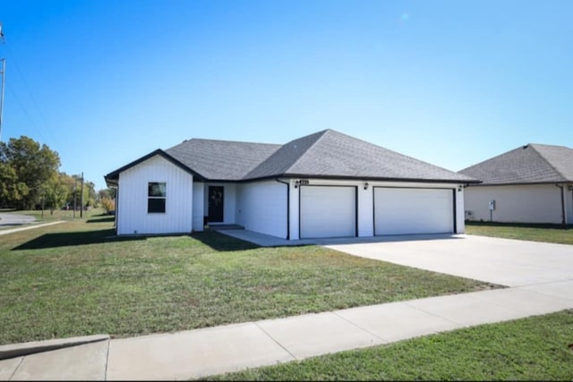 view of front facade with a garage and a front lawn