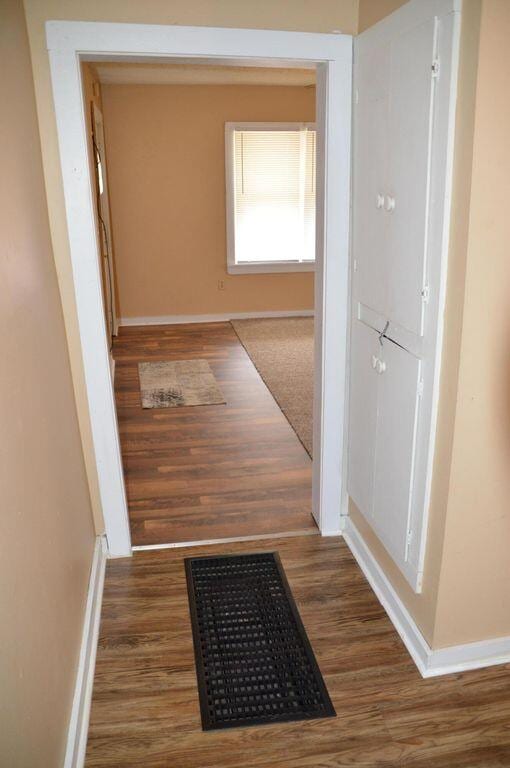 corridor featuring dark hardwood / wood-style floors