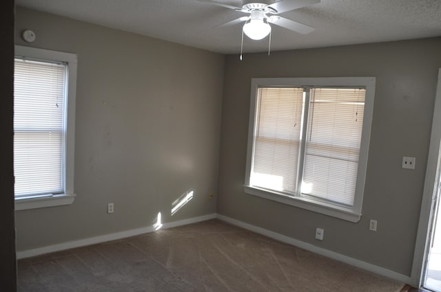 unfurnished room featuring a textured ceiling, ceiling fan, and carpet flooring