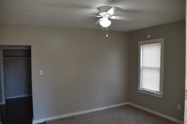 unfurnished bedroom with ceiling fan, a closet, and a textured ceiling