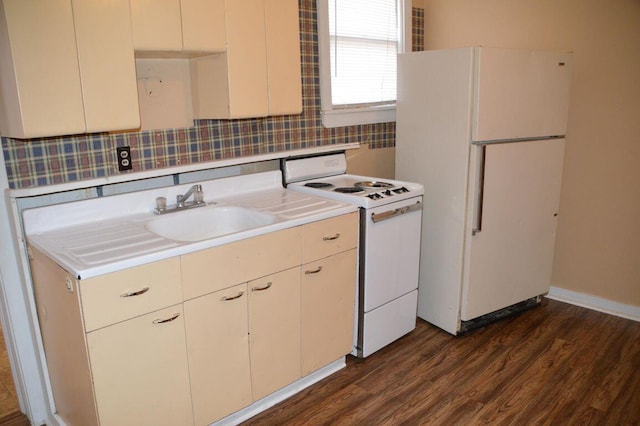 kitchen featuring dark wood-type flooring, backsplash, sink, and white appliances