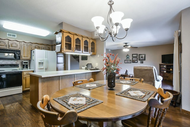 dining room featuring ceiling fan with notable chandelier and dark wood-type flooring