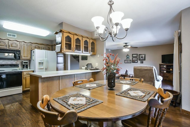 dining area with ceiling fan with notable chandelier, visible vents, and dark wood-type flooring