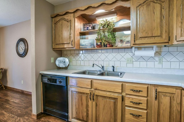 kitchen with light countertops, a sink, backsplash, and black dishwasher