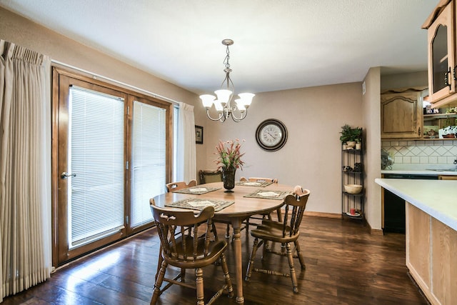 dining area with an inviting chandelier and dark hardwood / wood-style flooring