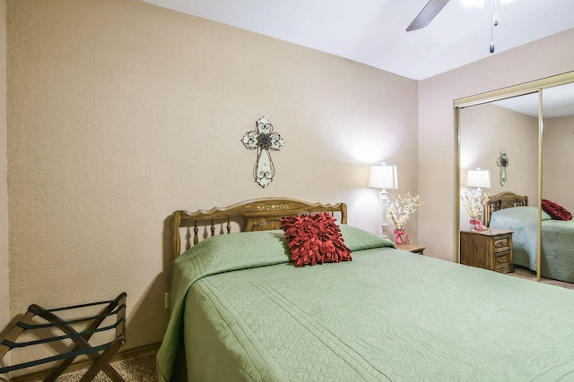 carpeted bedroom with ceiling fan and a closet