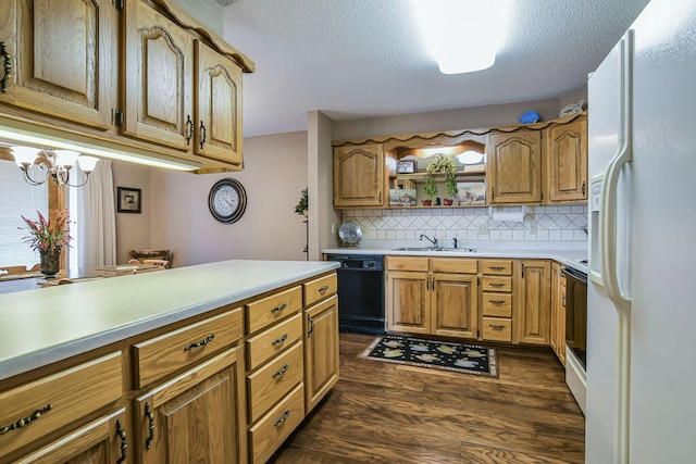 kitchen featuring a sink, decorative backsplash, white fridge with ice dispenser, light countertops, and black dishwasher
