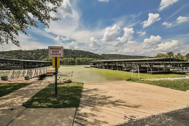 dock area featuring a forest view