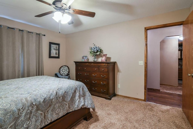 carpeted bedroom with baseboards and a ceiling fan