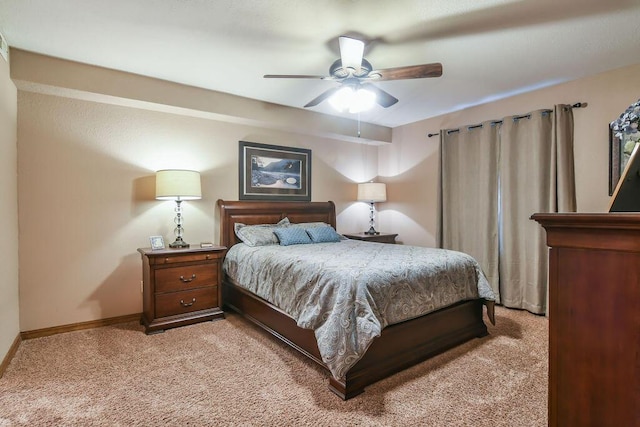 bedroom with ceiling fan, baseboards, and light colored carpet