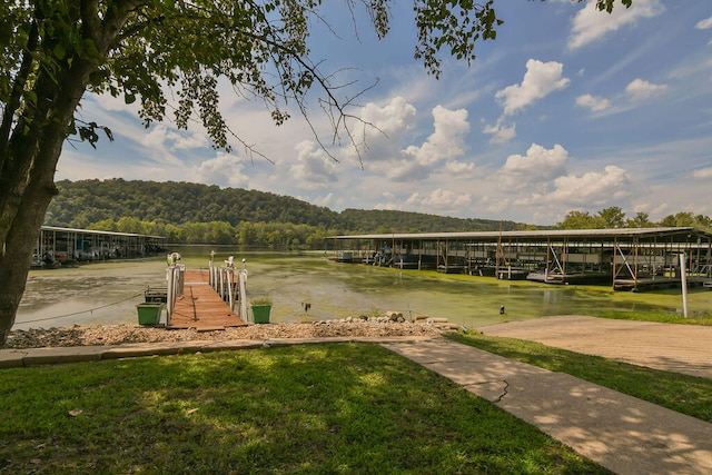 view of property's community with a water view and a dock