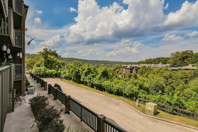 view of community with a wooded view
