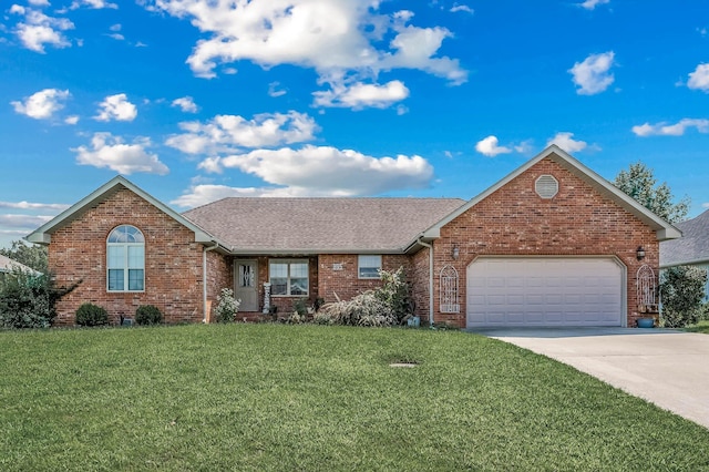 view of front of house featuring a garage and a front lawn