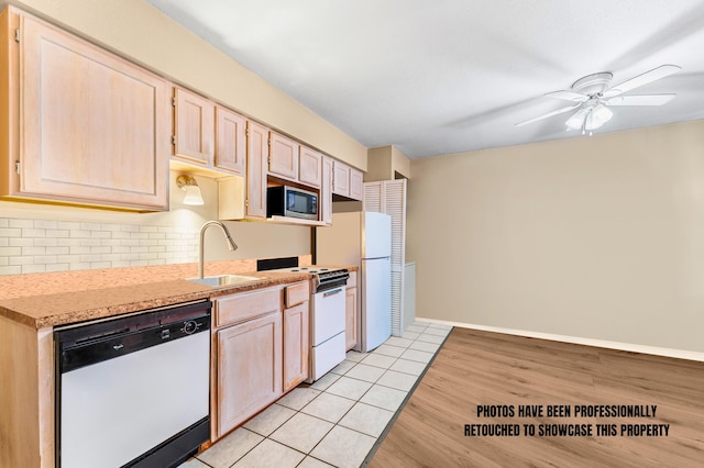 kitchen featuring light hardwood / wood-style floors, ceiling fan, white appliances, light brown cabinets, and sink