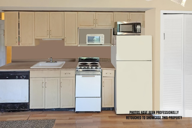 kitchen with white appliances, light hardwood / wood-style floors, cream cabinets, and sink