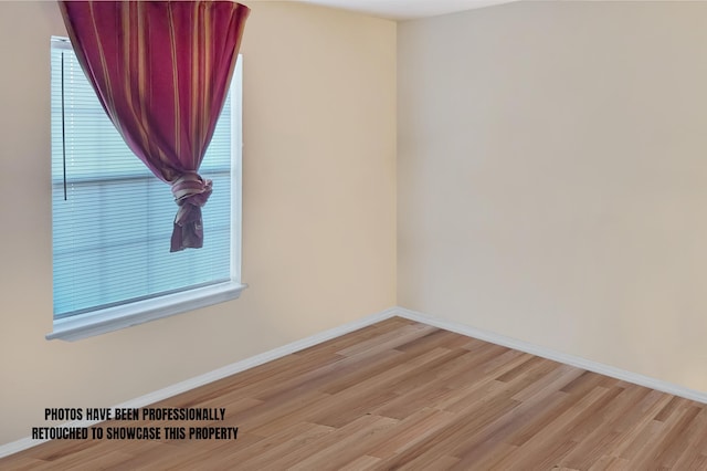 unfurnished room with light hardwood / wood-style floors