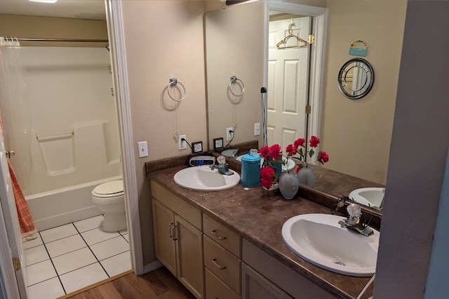 full bathroom featuring shower / bath combination with curtain, vanity, toilet, and hardwood / wood-style flooring