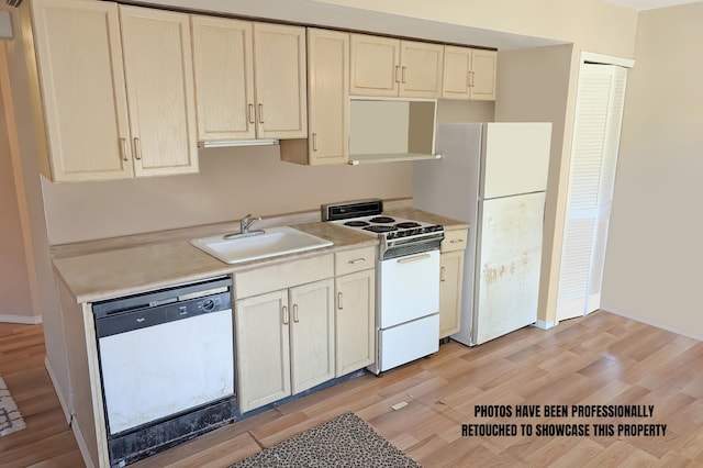 kitchen featuring white appliances, light hardwood / wood-style floors, and sink