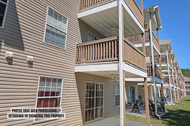 view of property exterior with a patio and a balcony