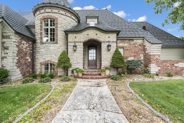 view of exterior entry featuring a yard