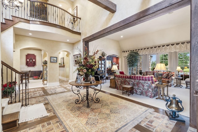 foyer entrance featuring a high ceiling and beam ceiling