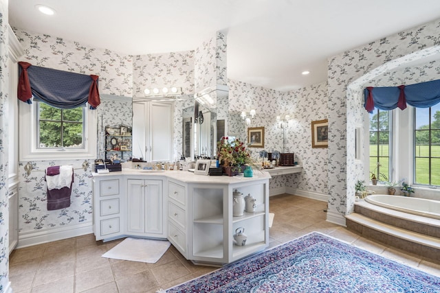 bathroom with a bathing tub, tile patterned flooring, and vanity