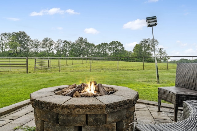 view of patio with a rural view and a fire pit