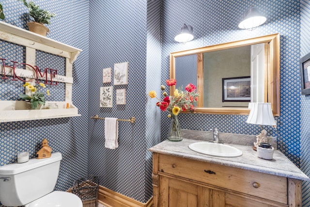 bathroom featuring vanity and toilet